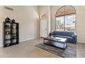 Bright living room featuring tile floors, a large window, and stylish furniture at 18601 N 16Th Pl, Phoenix, AZ 85024