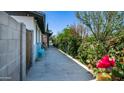 Charming home exterior featuring a blue bench and lush garden along the side of the house at 18829 N 23Rd Ave, Phoenix, AZ 85027