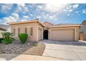 Charming single-story home featuring a tile roof, multiple garage spaces and desert landscaping at 24127 N 166Th Ct, Surprise, AZ 85387