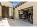 View of the two-car garage with open door showing the interior workshop and tools at 27315 N 83Rd Dr, Peoria, AZ 85383