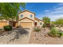 Inviting two-story house with desert landscaping, a front-facing two-car garage and a red front door at 28071 N Superior Rd, San Tan Valley, AZ 85143