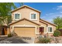 Charming two-story house with desert landscaping, a front-facing two-car garage and a red front door at 28071 N Superior Rd, San Tan Valley, AZ 85143