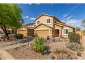 Inviting two-story house with desert landscaping, a front-facing two-car garage and a red front door at 28071 N Superior Rd, San Tan Valley, AZ 85143