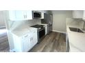 Stylish kitchen with new stainless steel appliances, white cabinetry, and modern countertops at 3154 E Clarendon Ave, Phoenix, AZ 85016