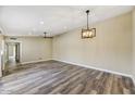 Spacious living room features modern lighting, new flooring, and neutral walls at 3154 E Clarendon Ave, Phoenix, AZ 85016