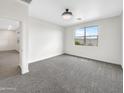 Bright bedroom with a large window and neutral carpet and walls at 32341 N Union St, San Tan Valley, AZ 85143