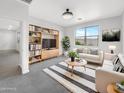 Bright living room with stylish furniture, a large window, and a decorative entertainment center at 32341 N Union St, San Tan Valley, AZ 85143