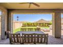 Inviting covered patio with a ceiling fan and outdoor seating area at 33275 N 132Nd Ave, Peoria, AZ 85383