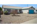 Lovely single-story home with a turquoise garage door and easy-care desert landscaping at 3417 W Abraham Ln, Phoenix, AZ 85027