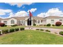 Stunning single-story home featuring a well-manicured lawn, elegant architecture, and a circular driveway at 3528 E Decatur St, Mesa, AZ 85213