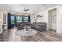 Inviting living room boasts a sectional sofa, sleek ceiling fan, and a decorative accent wall at 3855 S Mcqueen Rd # 24, Chandler, AZ 85286