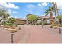 Beautiful home exterior with lush landscaping, palm trees, and a welcoming driveway leading to the entrance at 4055 N Recker Rd # 82, Mesa, AZ 85215