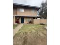 Charming two-story home with a tidy lawn, colorful flowering bushes and blue entry door at 4219 N 69Th N Ln # 1319, Phoenix, AZ 85033