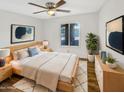 A serene bedroom with ample natural light and stylish decor at 4247 N 101St Ave, Phoenix, AZ 85037