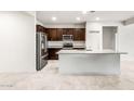 Modern kitchen featuring stainless steel appliances and a large island with granite countertops at 5091 S 251St Dr, Buckeye, AZ 85326