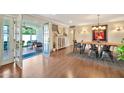 Elegant dining room featuring wood floors, modern lighting, and stylish decor with French doors to a patio at 512 W Seldon Ln, Phoenix, AZ 85021