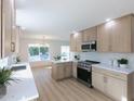 Modern kitchen features stainless steel appliances, white countertops, and light wood cabinets at 5564 N 77Th Pl, Scottsdale, AZ 85250