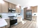 Updated kitchen with stainless steel appliances, white counters, and light wood cabinets at 5564 N 77Th Pl, Scottsdale, AZ 85250