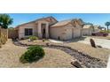Beautiful home features a two-car garage, desert landscaping and unique rock drainage at 6539 W Briles Rd, Phoenix, AZ 85083