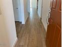 Inviting entryway showcasing wood-look tile flooring that flows into the home's living spaces at 7417 E Hackamore Ln, San Tan Valley, AZ 85143