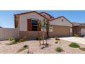 Charming single-story home with a two-car garage, low-maintenance landscaping, and a welcoming front entrance at 7417 E Hackamore Ln, San Tan Valley, AZ 85143