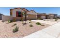 Charming single-story home with a two-car garage, low-maintenance landscaping, and a welcoming front entrance at 7417 E Hackamore Ln, San Tan Valley, AZ 85143