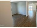 Bright living area with wood-look tile flooring, neutral walls and view into the large backyard at 7417 E Hackamore Ln, San Tan Valley, AZ 85143