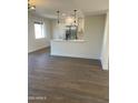 Open-concept kitchen with white cabinets, stainless appliances, and a large eat-in island at 7637 E Akron St, Mesa, AZ 85207