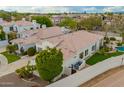 Rear aerial view of property with a lush backyard, and a large grassy space at 7678 E Cactus Wren Rd, Scottsdale, AZ 85250