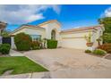 Attractive home exterior featuring a tile roof, desert landscaping, and a spacious three car garage at 7678 E Cactus Wren Rd, Scottsdale, AZ 85250