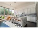 Modern kitchen features an island with seating, marble countertops and stainless appliances at 7703 E Overlook Dr, Scottsdale, AZ 85255