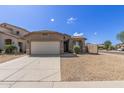 Inviting single-Gathering home with a two-car garage, desert landscaping, and concrete driveway at 10245 W Parkway Dr, Tolleson, AZ 85353