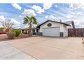 Welcoming house with desert landscape, palm tree, and a large driveway at 1153 W Mesquite St, Chandler, AZ 85224