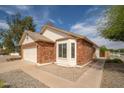 Charming brick home with a well-maintained front yard and bay window at 1200 W Boxelder Cir, Chandler, AZ 85224