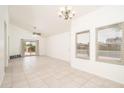Spacious living room with neutral walls, tile flooring, and access to the patio at 1200 W Boxelder Cir, Chandler, AZ 85224