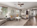 Inviting living room with neutral colors, plush seating, and a ceiling fan for added comfort at 12057 W Ashby Dr, Peoria, AZ 85383