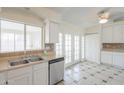 Clean kitchen with white cabinets, stainless steel dishwasher and view to patio doors at 1297 E Avenida Kino --, Casa Grande, AZ 85122