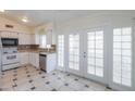 Well-lit kitchen featuring white cabinetry, stainless steel appliances, and access to patio doors at 1297 E Avenida Kino --, Casa Grande, AZ 85122