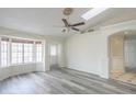 Bright and airy living room featuring wood-look floors, a ceiling fan, and ample natural light at 1297 E Avenida Kino --, Casa Grande, AZ 85122