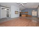 Inviting living room with high ceilings and an open layout leading to the kitchen at 15035 W Indianola Ave, Goodyear, AZ 85395
