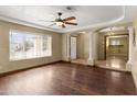 Inviting living room with a ceiling fan, hardwood floors and decorative columns at 15619 N 58Th Ave, Glendale, AZ 85306