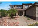 Charming front entry with stone accents and well-maintained landscaping at 15834 W Port Au Prince Ln, Surprise, AZ 85379