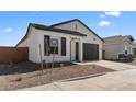Beautiful single-story home with a well-manicured front yard, dark shutters, and a two-car garage at 16575 N Lunar St, Maricopa, AZ 85138