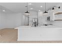 Bright, modern kitchen with stainless steel appliances, a large island, and pendant lighting at 16575 N Lunar St, Maricopa, AZ 85138