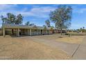 View of the exterior of a well maintained home with carport and desert landscaping under a bright blue sky at 1719 E Pinchot Ave, Phoenix, AZ 85016