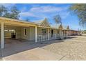 Exterior view of house featuring a carport, desert landscaping, and vintage architectural details at 1719 E Pinchot Ave, Phoenix, AZ 85016