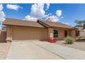 Inviting single-story home with a 2-car garage, showcasing a neat front yard for low-maintenance desert living at 1750 W Mohawk Ln, Phoenix, AZ 85027