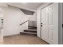 Bright entryway with neutral paint, tile floors, and a staircase leading to the upper level at 1761 E 38Th Ave, Apache Junction, AZ 85119