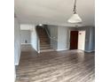 Entryway with open staircase and new wood-look floors at 1876 N Parkside Ln, Casa Grande, AZ 85122