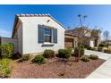 Charming house with a small yard with low maintenance landscaping, shutters, and a window at 21056 W Granada Rd, Buckeye, AZ 85396